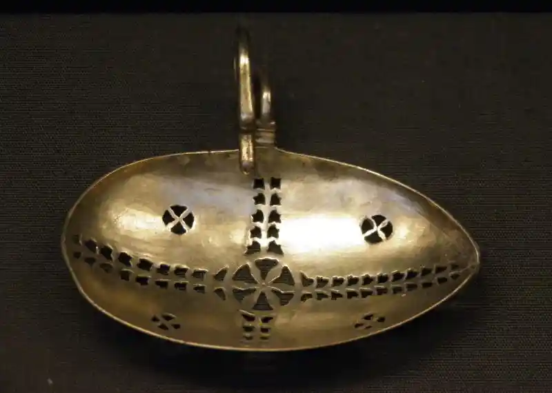 Silver strainer-spoon with straining holes in the form of a cross
